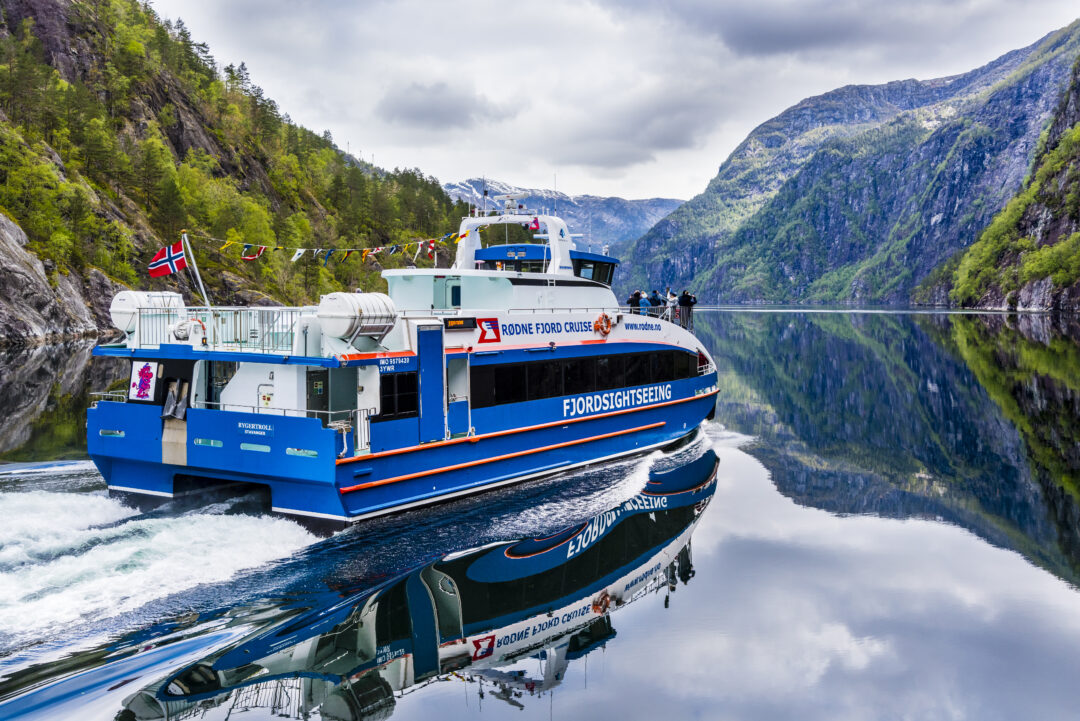 A scenic fjord cruise from Bergen, sailing through Norway’s breathtaking Osterfjord with steep mountains and waterfalls