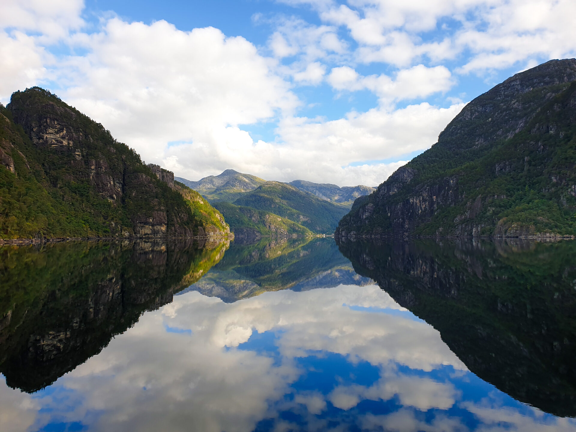 The fjord scenery mirroring in the fjord on the way to Mostraumen