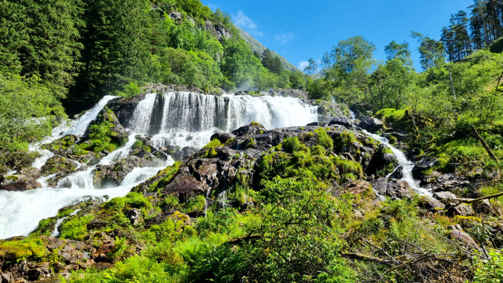 The powerful Hattebergsfossen waterfall cascading down the mountains near Rosendal, a must-visit natural attraction in the Hardangerfjord region.