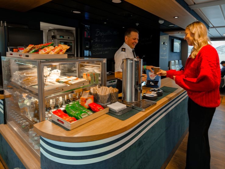 Girl interacting with crew aboard Rygerdronningen in Tromsø. Enjoing the big licensed kiosk