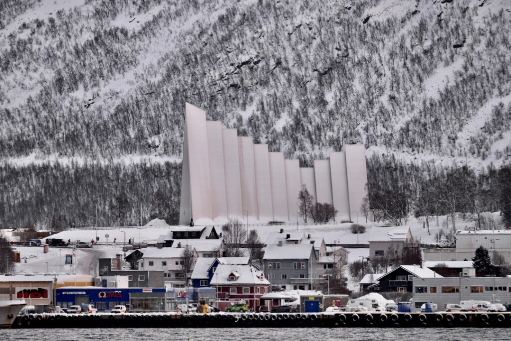 Close-up view of Tromsø’s Arctic Cathedral seen from Rødne boat during Arctic fjord cruise in Northern Norway.