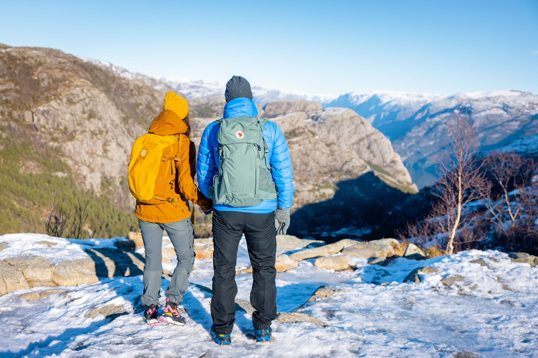 Two hikers enjoying nature in solitude, this is a once-in-a-lifetime winter journey with views over Lysefjord.