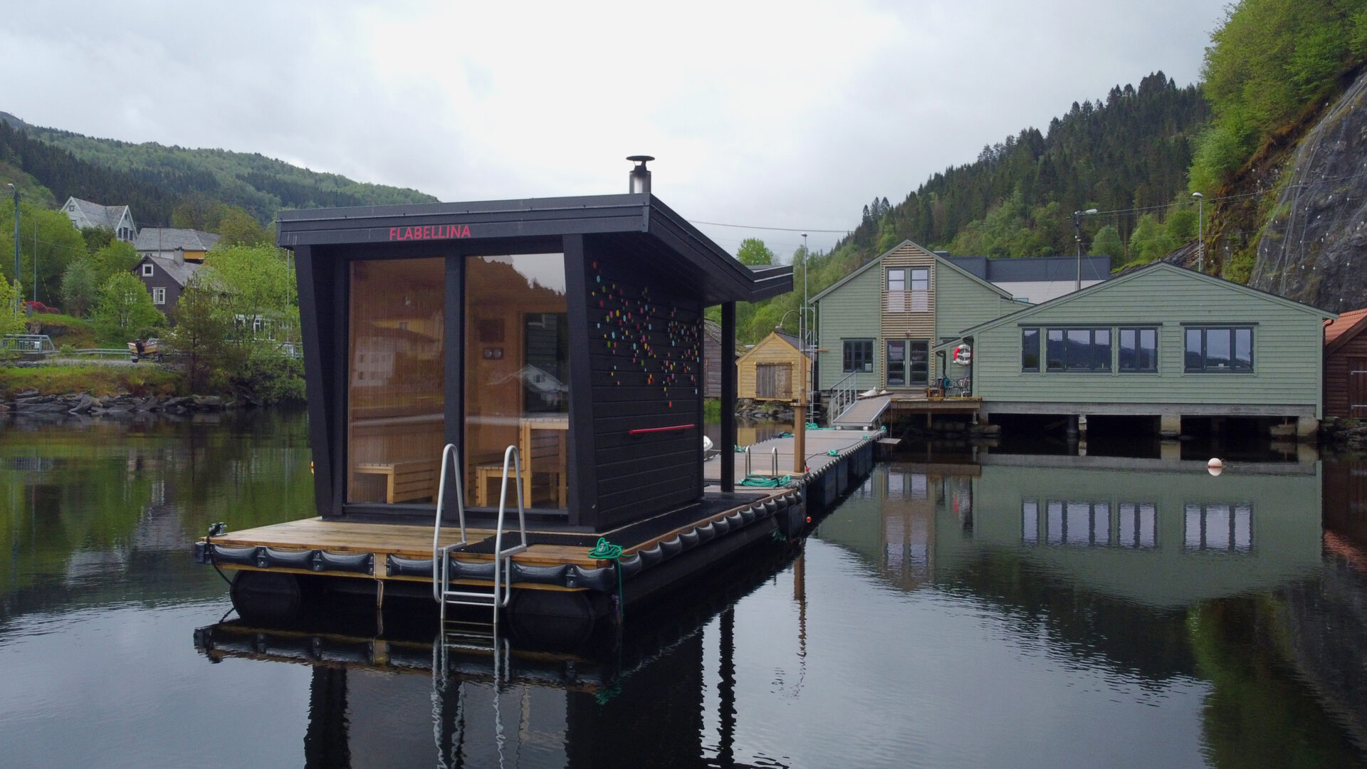 Contemporary floating sauna docked on the fjord with scenic views in Hosanger