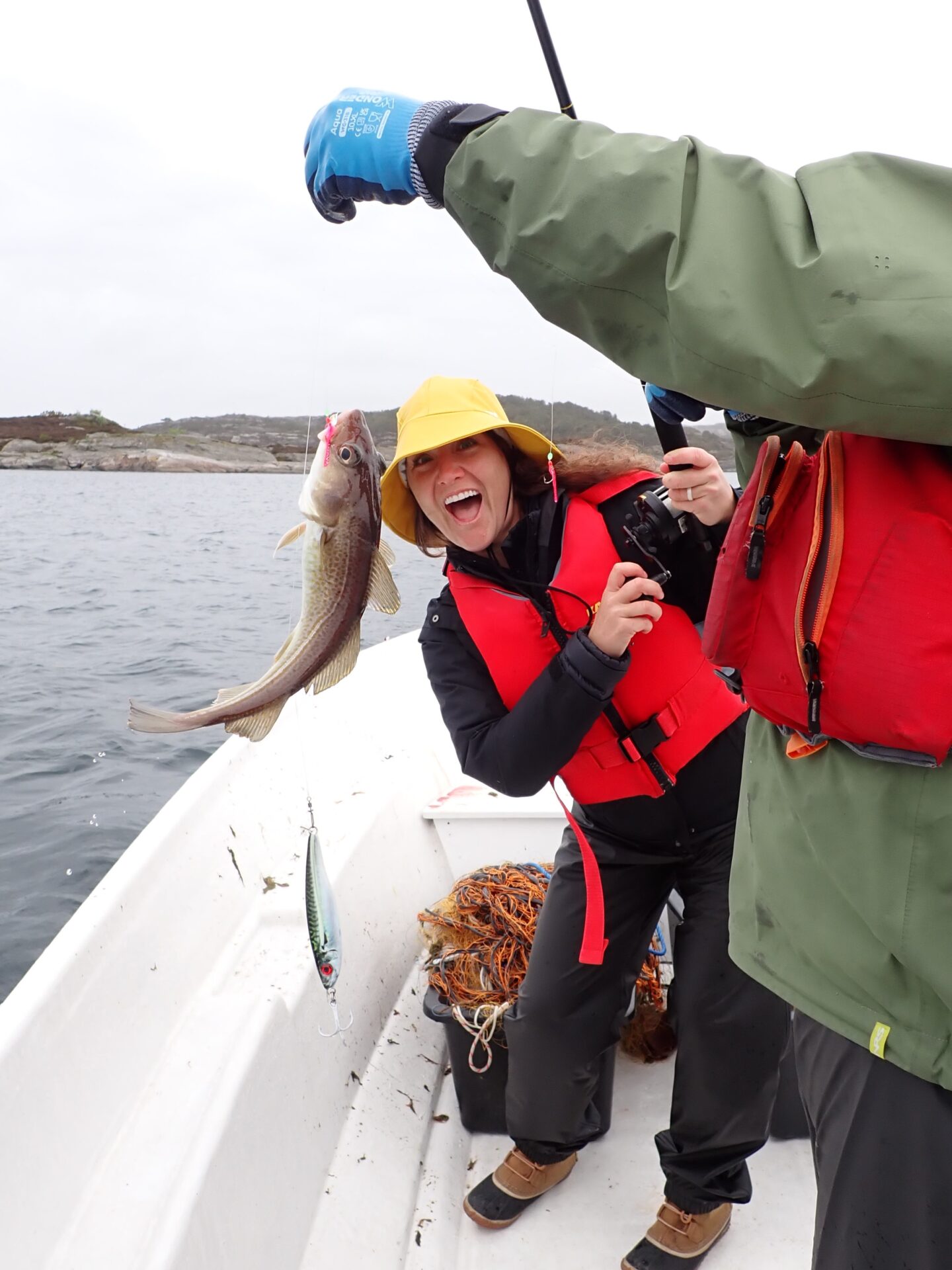 Two friends holding a fish caught in Lysefjord